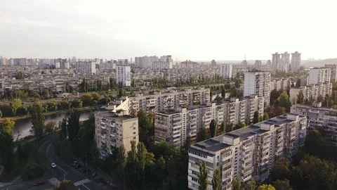Large tranquil residential area with trees around and a flowing river at sunset Stock Footage 147381124