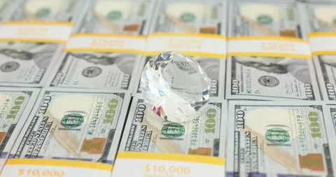 Large transparent Diamond on stack of hundred dollar bills Stock Footage 287553605