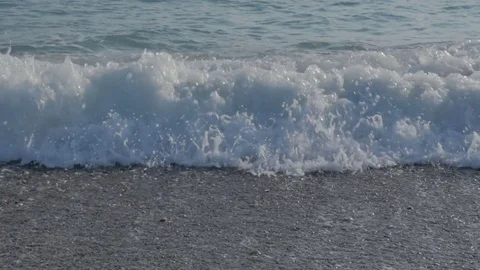 Large transparent waves with foam. Sea pebble beach with colorful stones 스톡 동영상 80048982