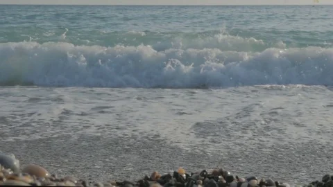 Large transparent waves with foam. Sea pebble beach with colorful stones Stock-Footage 80072938