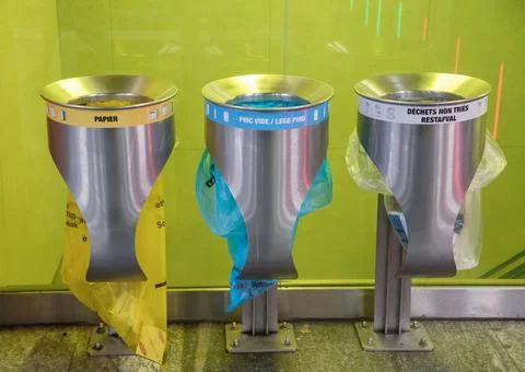 Large trash cans with multi-colored plastic bags to identify the type of waste Stock Photos