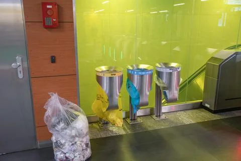 Large trash cans with multi-colored plastic bags to identify the type of waste Stock Photos