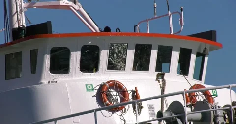 Large trawler in harbour reflections in windows Video stock 154200376