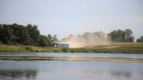 Large truck is driving through th countryside road Stock Footage 153209937