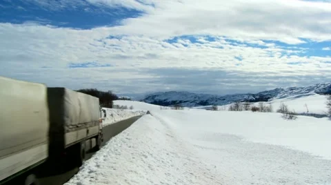 Large truck passing at snowy road on the mountain Stock Footage