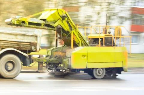 A large truck, pulls a device for cleaning the city streets. photo in motion Stock Photos
