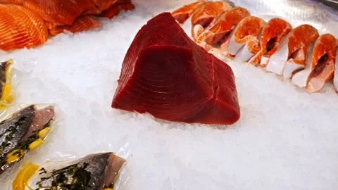 A large tuna steak is on the counter. Seafood shop. Video stock 166324125