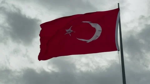 Large Turkish flag waving in wind against gray cloudy sky in Istanbul Stock Footage 346543810