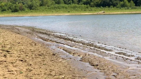 Large twin engine boat goes by on muddy land Stock Footage 121134456