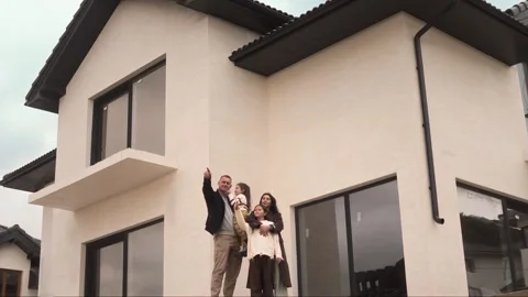 Large two storey new house and a big happy family with children. Stock Footage 307597163