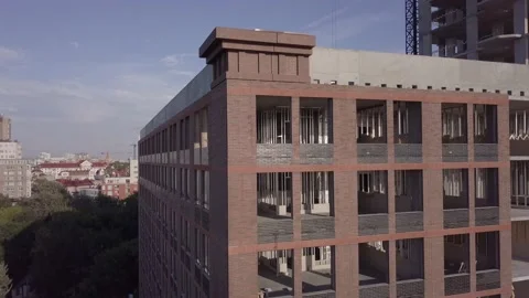 Large unfinished building corner with huge windows Stock Footage 157665386