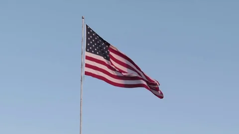 Large United States Flag waves in the breeze over US Route 66 Hwy in Kingman AZ 스톡 동영상 80407107