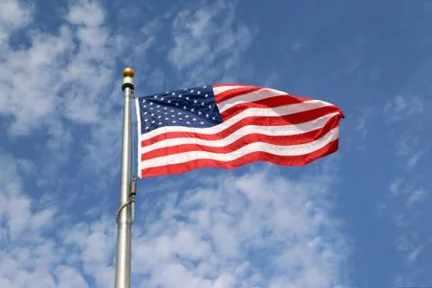 Large U.S. Flag "Old Glory" blowing in a strong wind against blue sky Foto stock