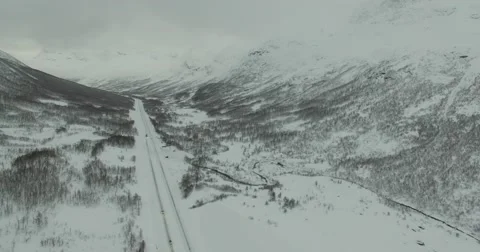 Large Valley with High Mountains in Snow and Icy Road - Aerial Stock Footage 60423653