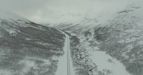Large Valley with High Mountains in Snow and Icy Road - Aerial Stock Footage 60426489