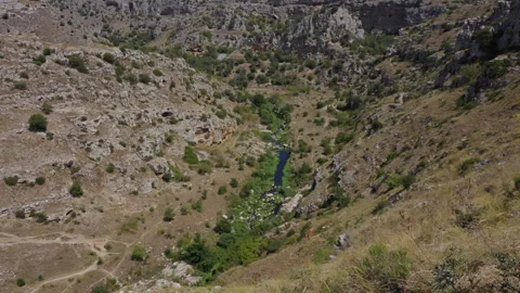 Large valley with a small river in the middle filmed from above. Version 1 Stock Footage 290175258