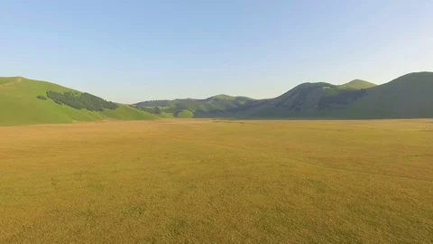 A large valley surrounded by mountains. Aerial drone video. Stock Footage 70351229