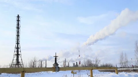 Large valve of the gas pipe, the smoke comes from the chimneys Stock Footage 46370081