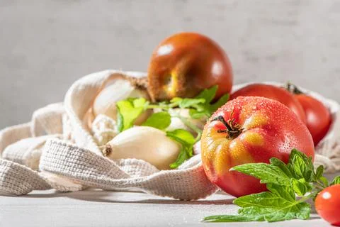 Large variety of tomatoes on rustic kitchen counter. Preparation of tomato sa Stock Photos