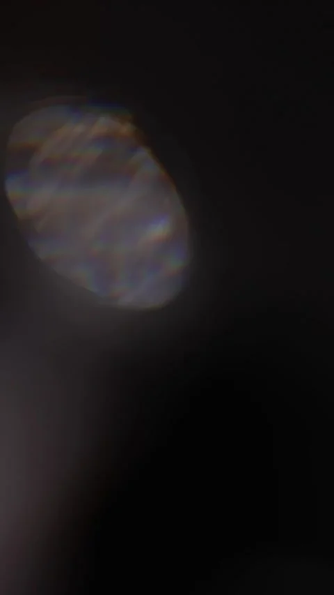 Large vertical iridescent light spot shimmering on a black background for d.. 스톡 동영상 341324936