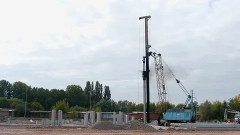 A large vertical piling crane equipped with a diesel hammer Stock Footage 165500549