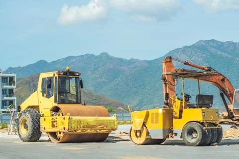 Large view on the big and small yellow road rollers working on the new modern Stock Photos