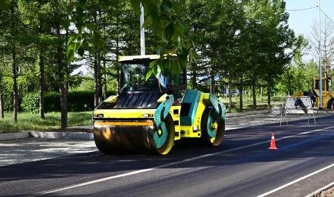Large view on the road rollers working on the new road construction site Stock Photos