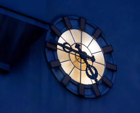 Large vintage old retro clock on urban street facade Stock Photos