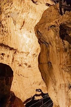 Large wall of calcite formations illuminated inside a high underground cave.. Stock Photos