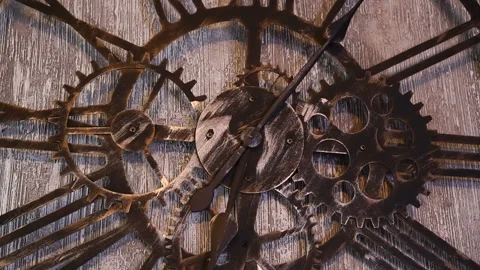 Large wall clock with Roman numerals, decorative gears and metal bezel. The loft Stock Footage 127299299
