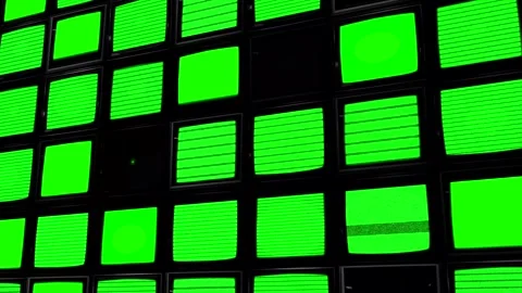 A large wall of green screen TV monitors. Key out the green to add your own Stock Footage 267706453