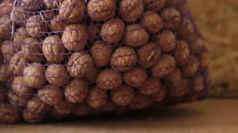 Large walnuts in bags of netting Stock Footage 60563472