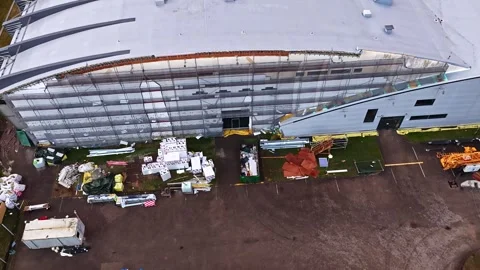 Large warehouse construction site during insulation process with scaffolding Stock Footage 335894136