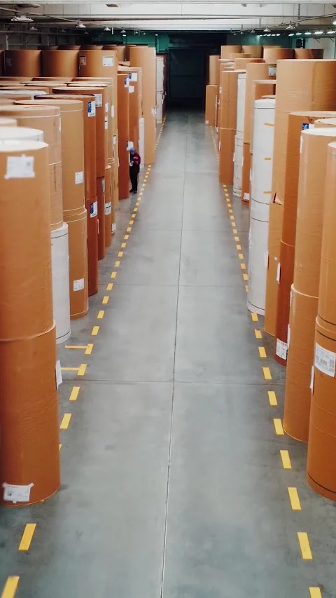 Large warehouse filled with paper rolls, Industrial warehouse housing stacked Stock Footage 323342426