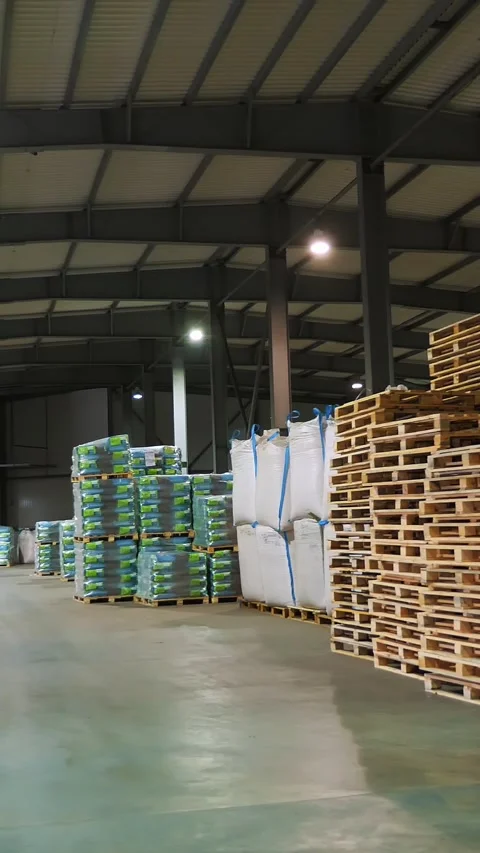 Large warehouse for grain storage, grain products such as corn, sunflower are in Stock-Footage 319017536