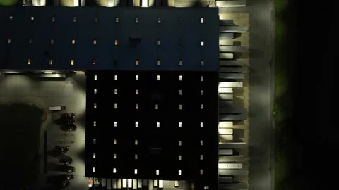 Large Warehouse Logistic park at night with parking trucks and container Stock Footage 274253103