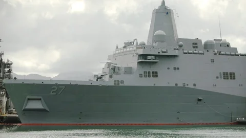 A large warship moored at the dock Stock Footage 117732843