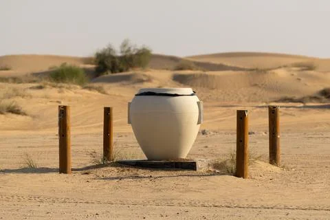 Large waste bin placed in the desert area Stock Photos