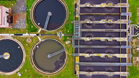 Large water treatment facility with multiple tanks and processing areas seen Stock Footage 331974321