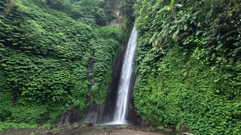 Large Waterfall Cascading Over River in Overcast Bali Landscape Stock Footage 339934215