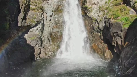 A large waterfall in close-up with a rainbow in the sun. Stock Footage 264092992