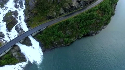 A large waterfall flows under the highway. Aerial view. Norway 動画素材 161271856