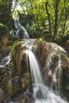 A large waterfall in a green forest Stock Photos