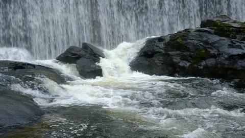 Large Waterfall -Wide shot of Gushing channel at the base - Slow motion Stock Footage 243785224