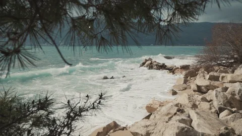 A large wave breaks on the shore Stock Footage 128684190