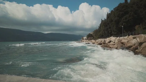 A large wave breaks on the shore Stock Footage 128685848