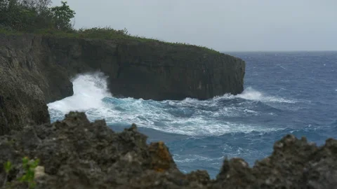 A large wave crashes against the rocks in a huge cloud of spray.  Rocky shore Stock Footage 154273470