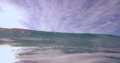 A large wave crashes over camera in Australian beach with bright day lighting. W Stock Footage 199460640