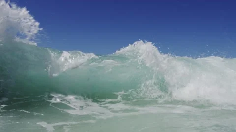 Large wave crashes on sandy shore in slow motion Stock Footage 56322060