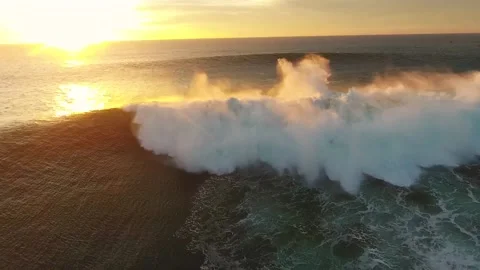 A large wave crashing at sunset Stock Footage 169275158